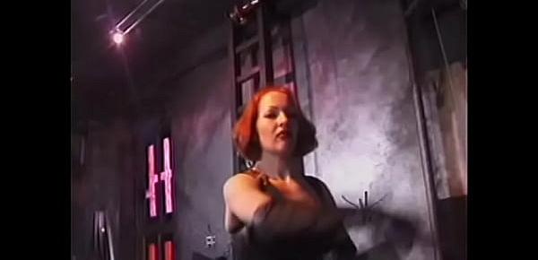  Red-haired whore in a leather corset makes a guy kiss her feet and then smacks him